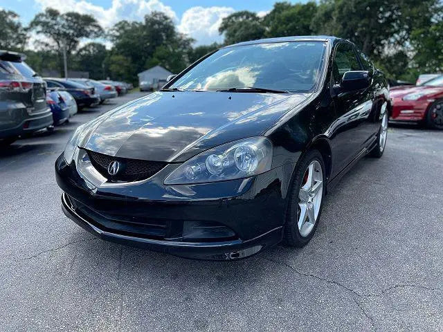 Acura RSX Base vs Type S comparison showcasing a sleek black vehicle in a parking lot