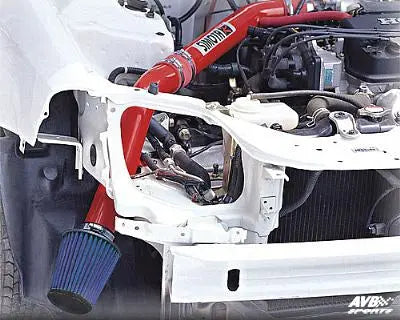 Detailed view of a cold air intake system installed in a car engine illustrating pros and cons of cold air intake systems
