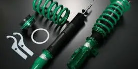 Tein coilovers benefits showcasing adjustable suspension components and installation tools on a dark background