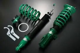 Tein coilovers benefits showcasing adjustable suspension components and installation tools on a dark background