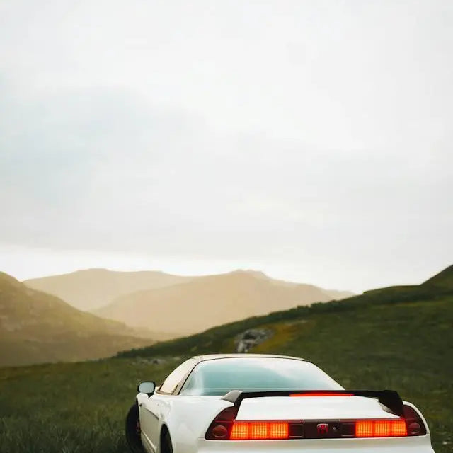 Classic Honda car in a scenic landscape illustrating Honda auto industry impact on automotive design