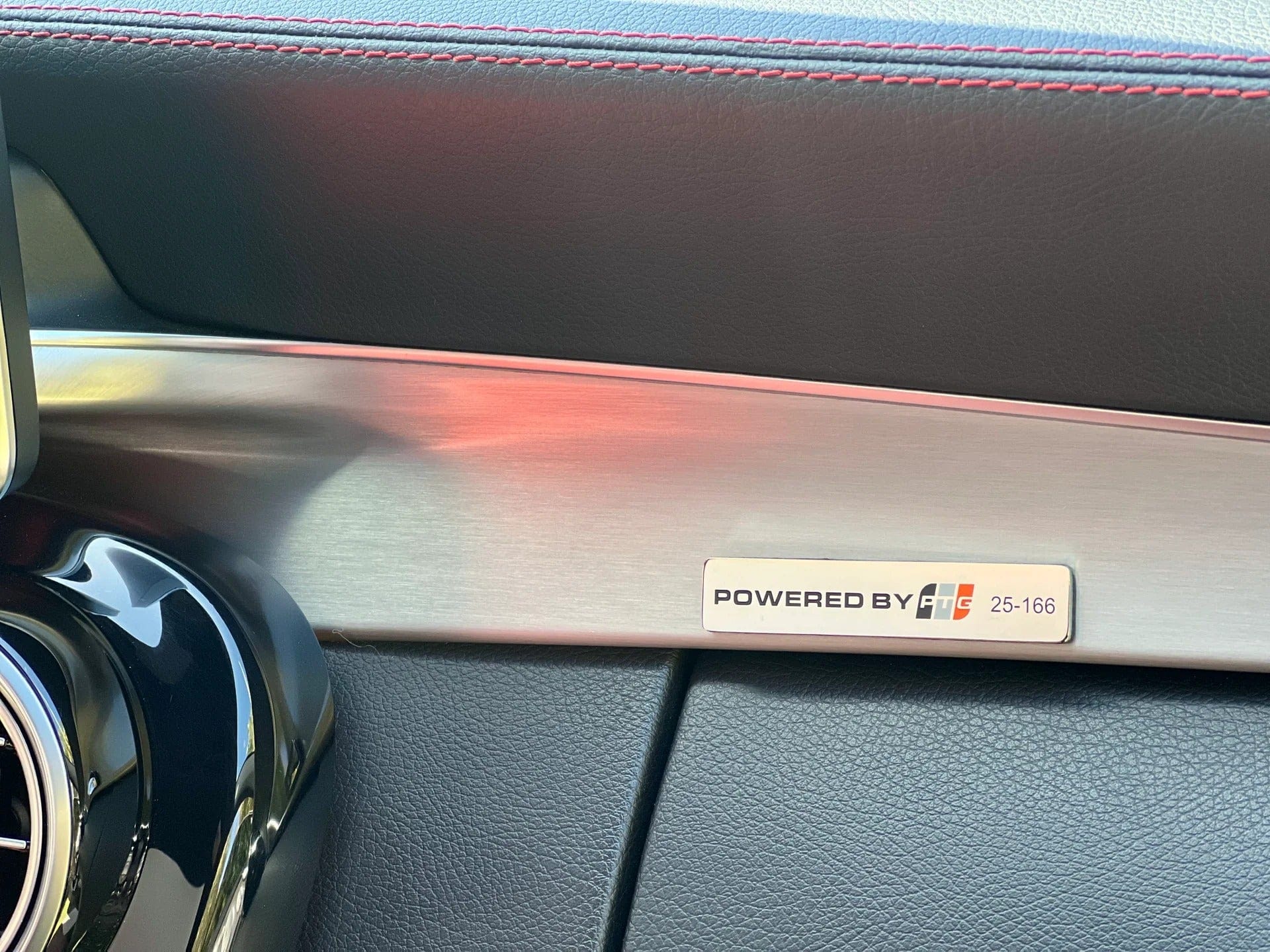 Interior dashboard badge showing Powered by TunerGenix for PTG 1000 M177.1 Turbo System