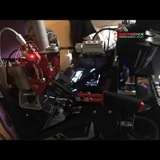 TunerGenix racing hydraulic handbrake with red and black design mounted on a performance simulator setup