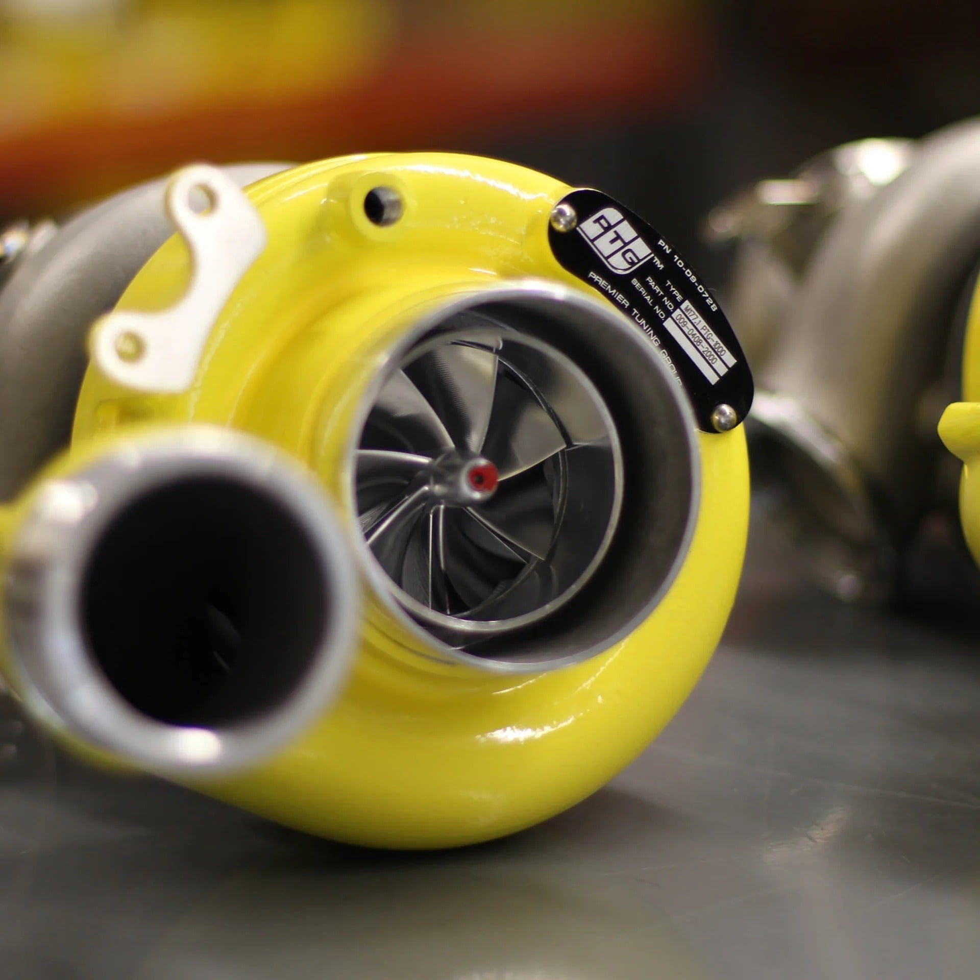 Close-up of PTG 1000 M177.1 Turbo System by TunerGenix with yellow housing and visible turbine blades